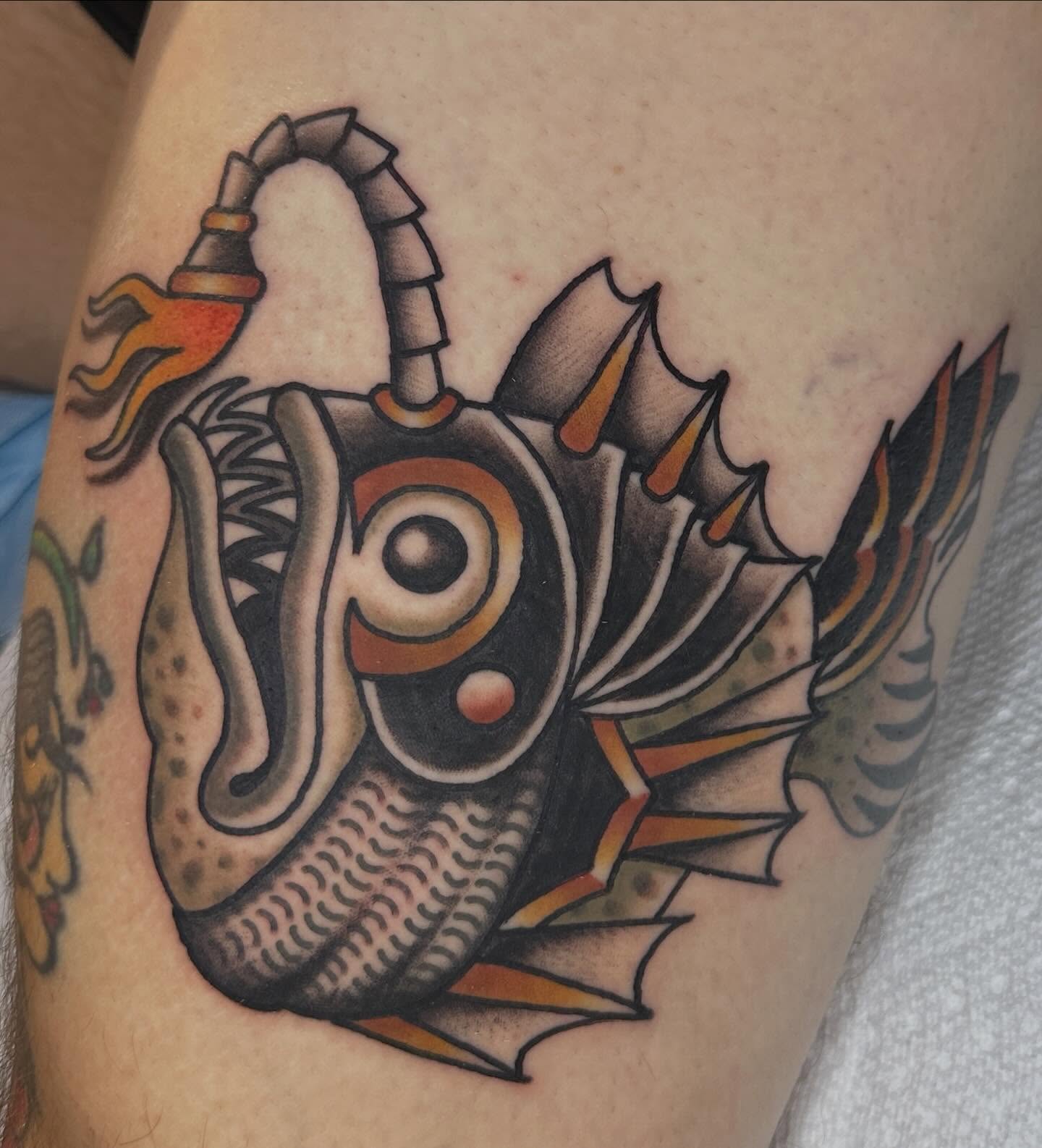 Fish American traditional tattoo on the upper arm by Kyle Logan Frary