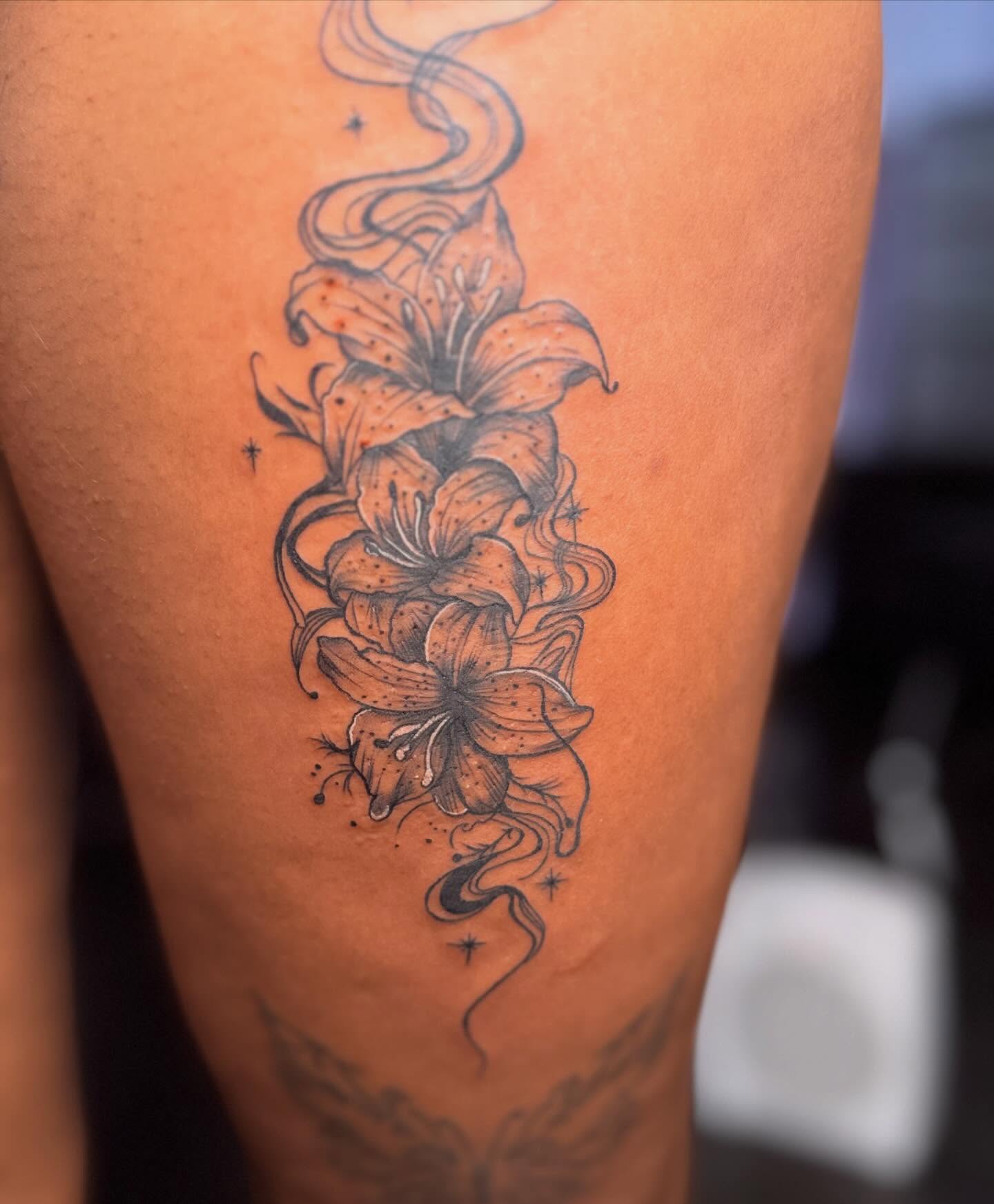 Lilies dotwork tattoo on the thigh by Jazz Walker