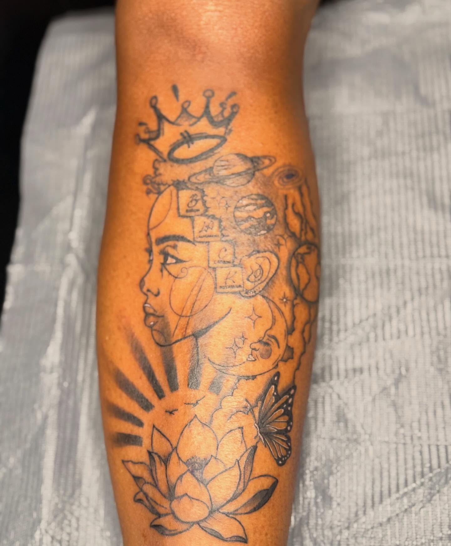 Woman's face with celestial symbols geometric tattoo on the forearm by Jazz Walker