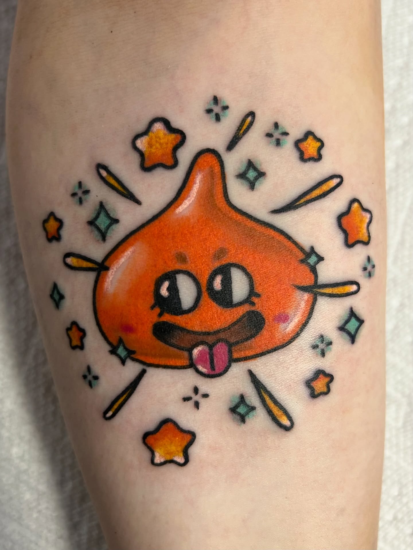 Orange droplet character new school tattoo on the forearm by Ollie