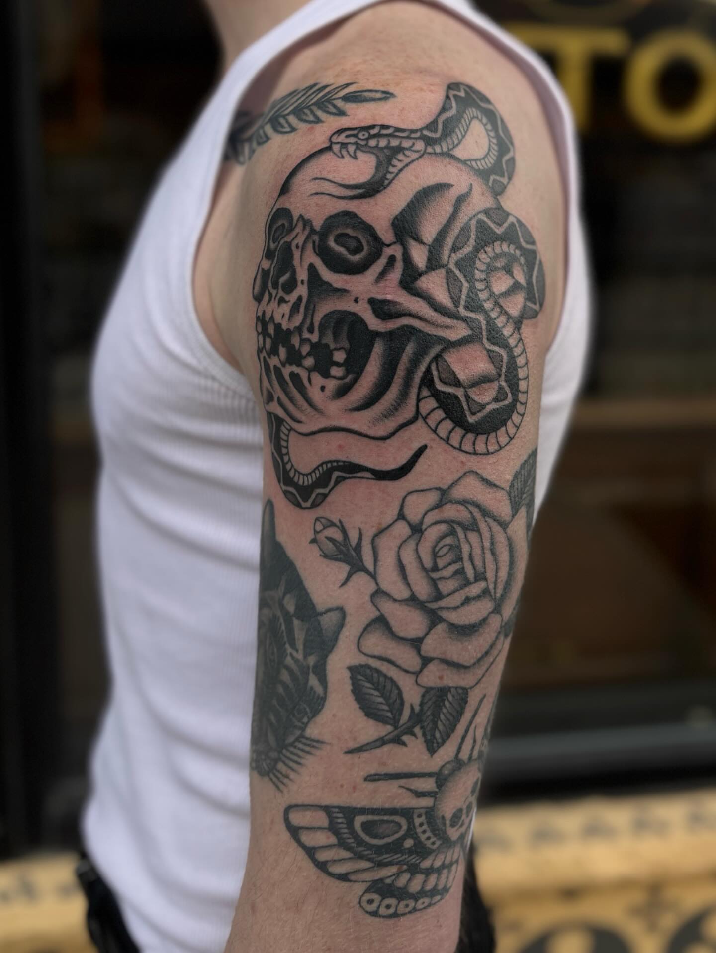 Skull and snake American traditional tattoo on the forearm by Jesse Smith, Chicago, Illinois