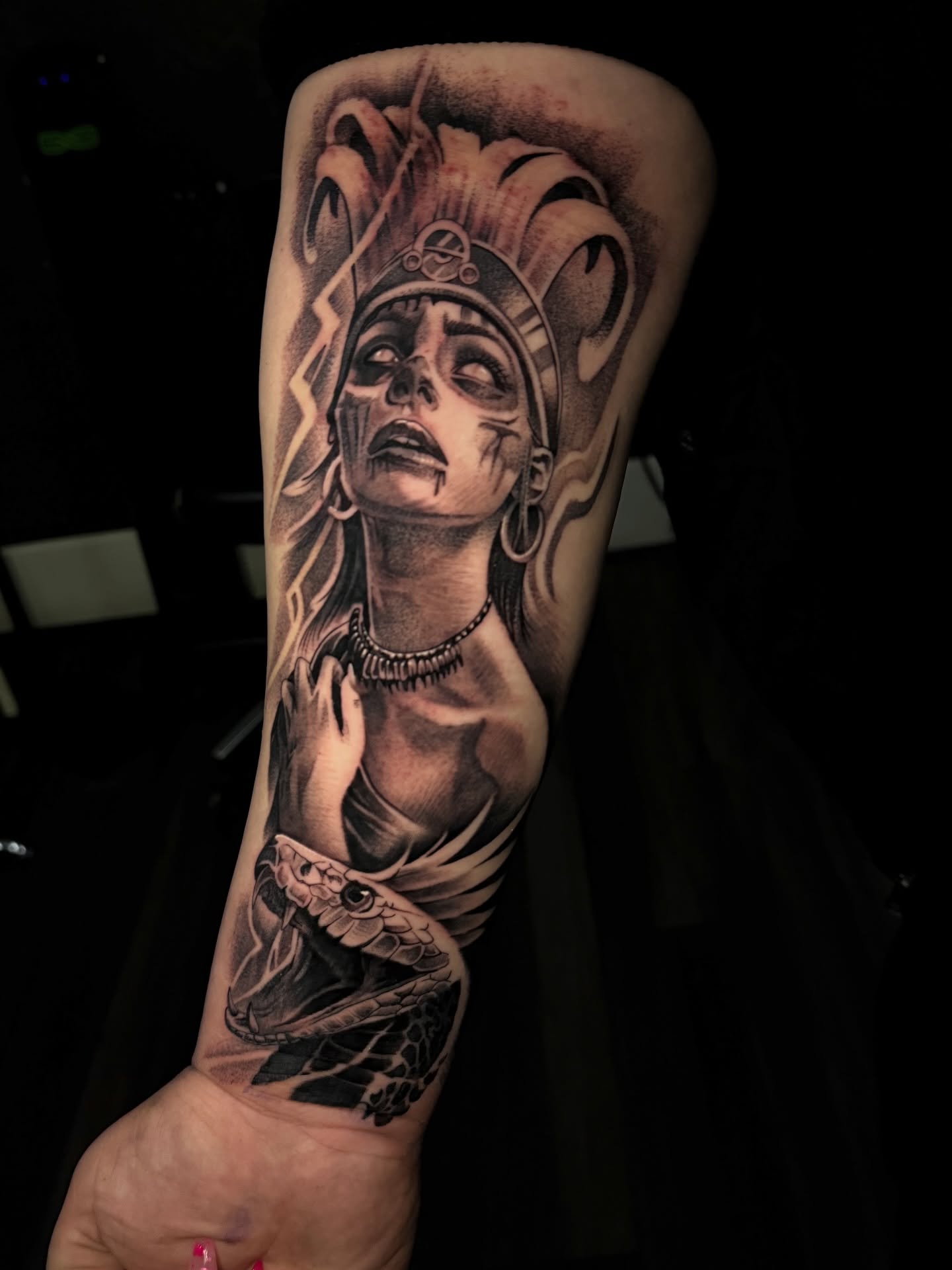 Woman with snake realism tattoo on the forearm by “Gonzo