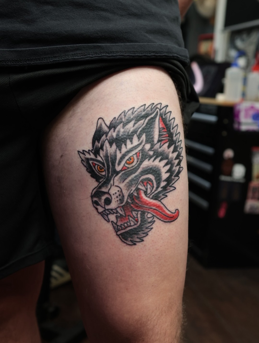 Wolf American traditional tattoo on the thigh by Chris Cockrill