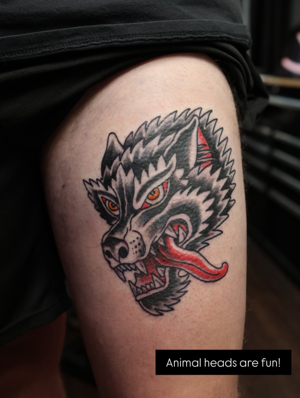 Wolf head American traditional tattoo on the thigh by Chris Cockrill