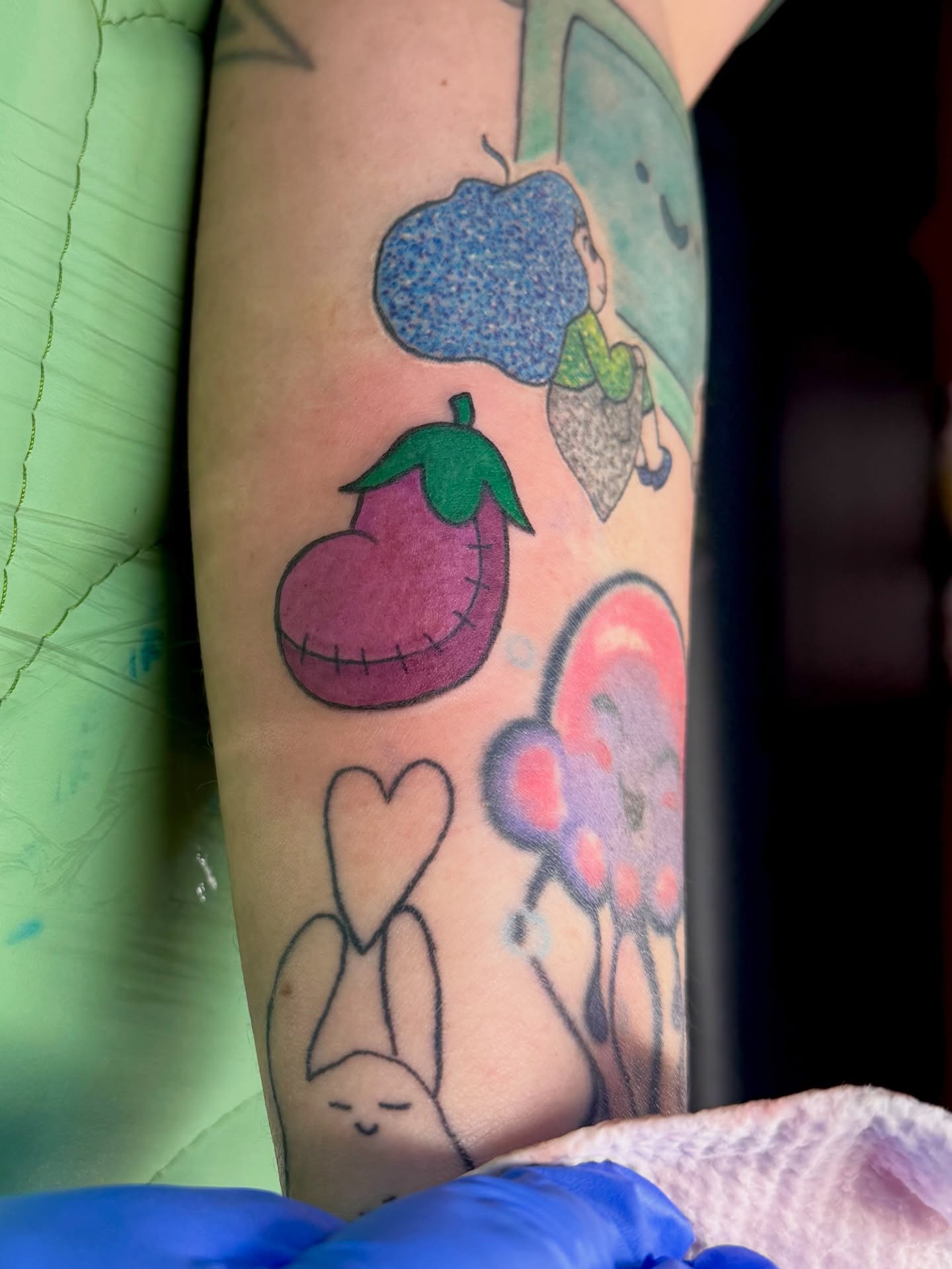 Fruit and character dotwork tattoo on the forearm by Minxxy Tattoos