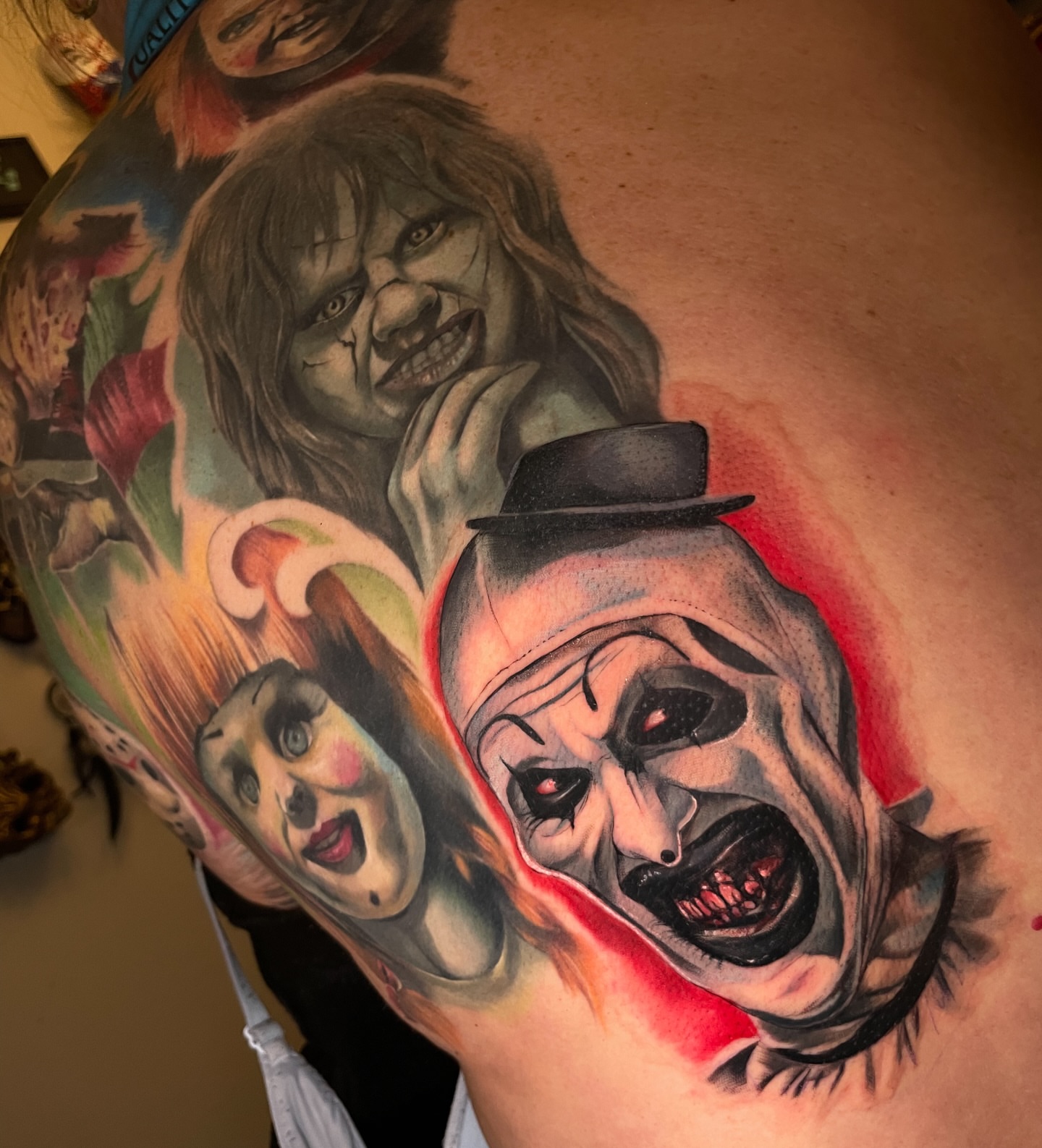 Clowns realism tattoo on the shoulder by Erica Olivier