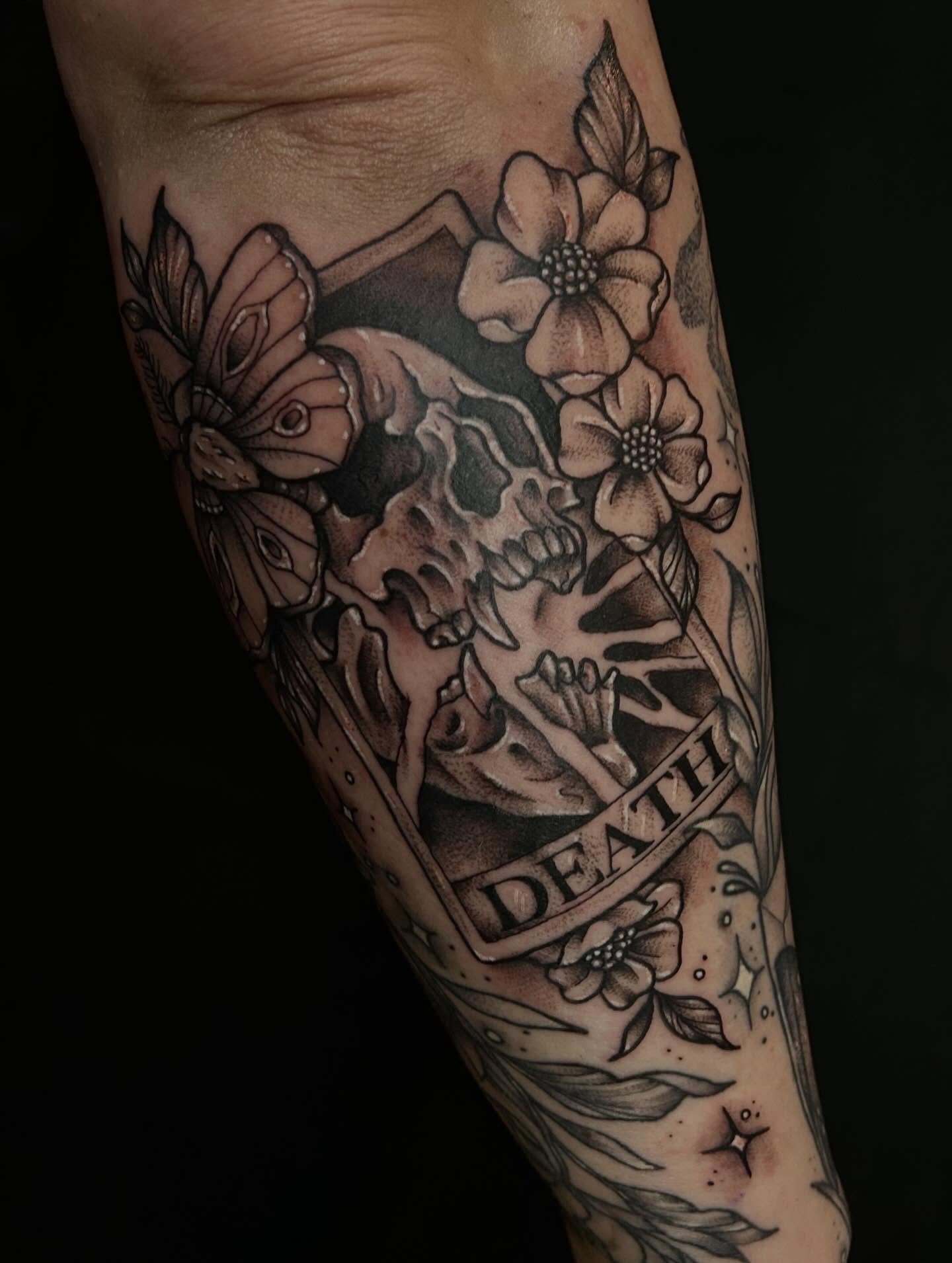 Skull and flowers realism tattoo on the forearm by abby ☽ marie