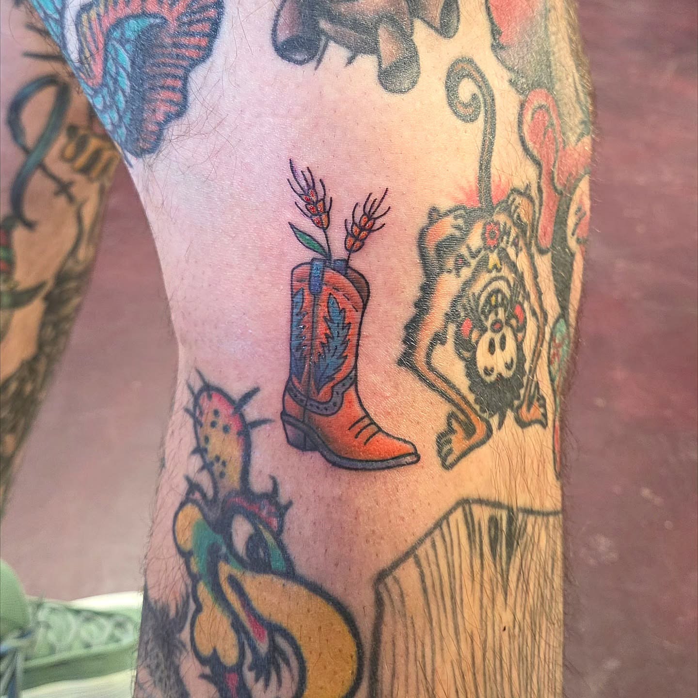 Cowboy boot and cactus American traditional tattoo on the forearm by Kat Coniglio Art