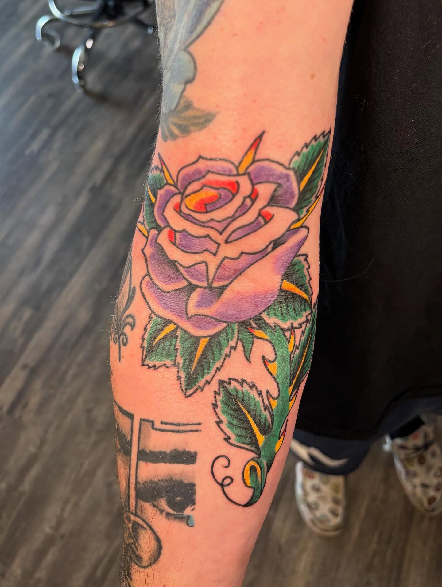Purple rose American traditional tattoo on the forearm by @seibastattoos, Virginia Beach, Virginia