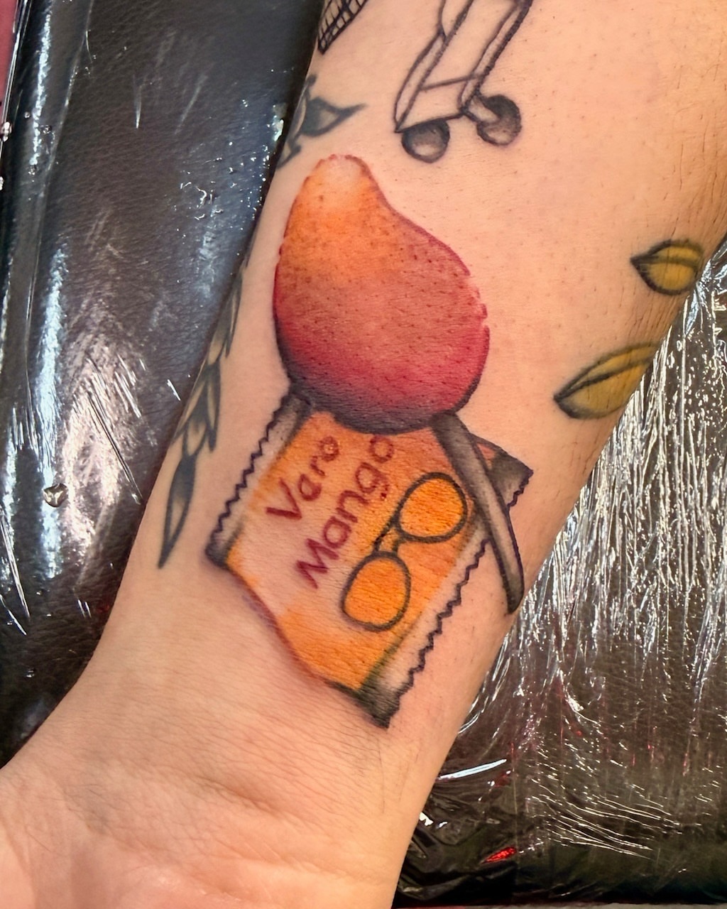 Mango ice cream bar realism tattoo on the forearm by Penny D Tattoos