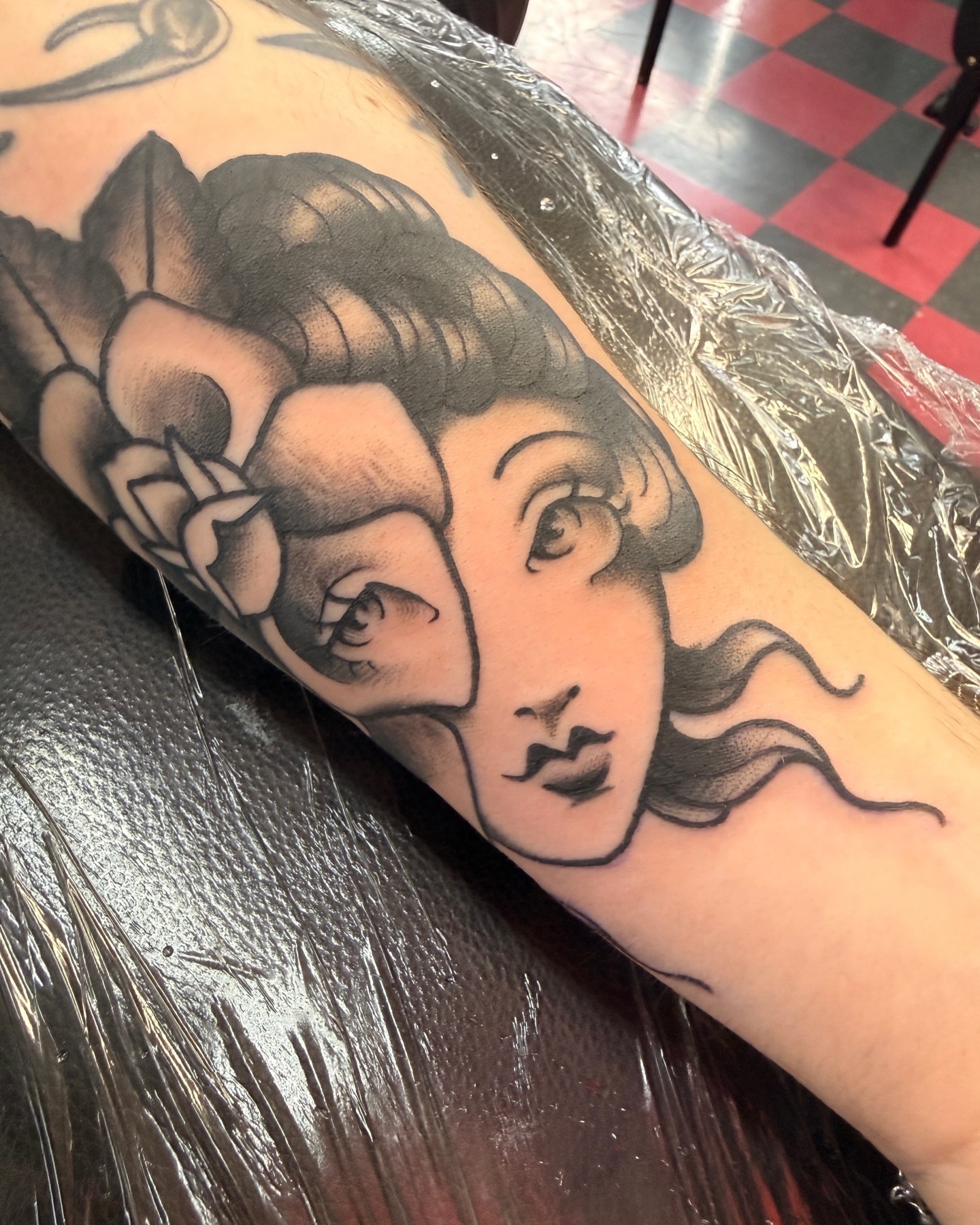 Woman's face black and grey tattoo on the forearm by Penny D Tattoos