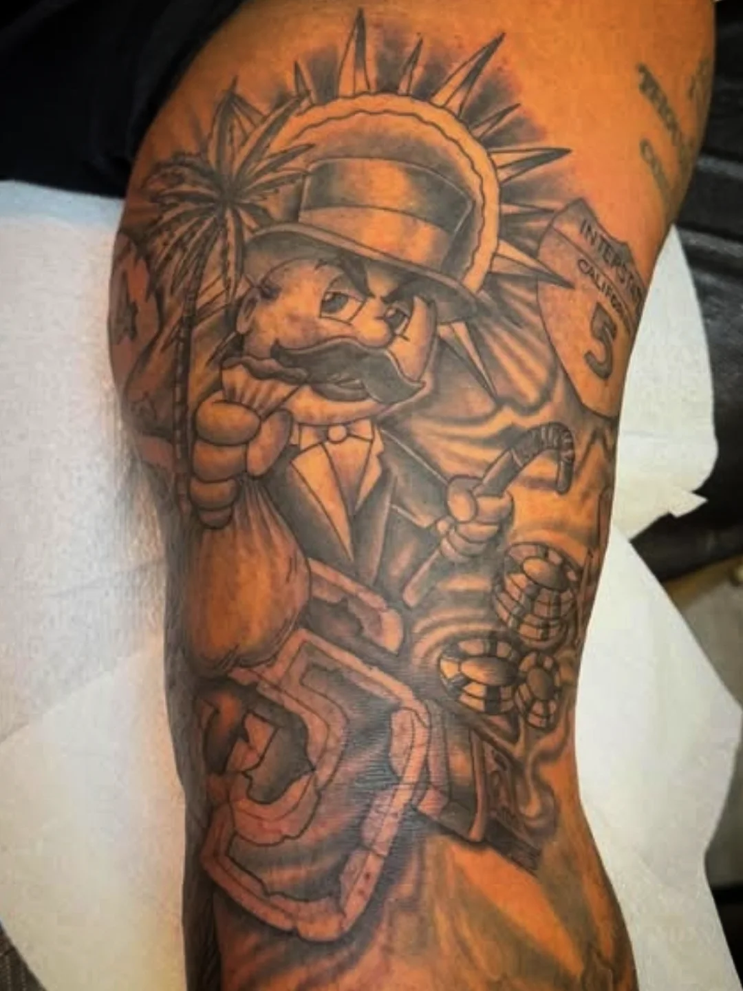 Man with mustache and top hat American traditional tattoo on the forearm by Josh Sroga