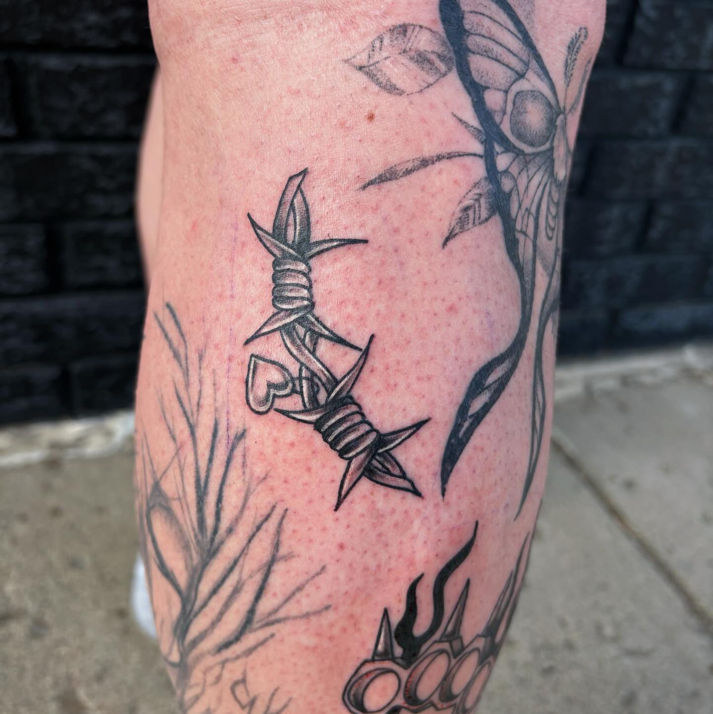 Barbed wire and flower black and grey tattoo on the forearm by Demi Flores 🖤