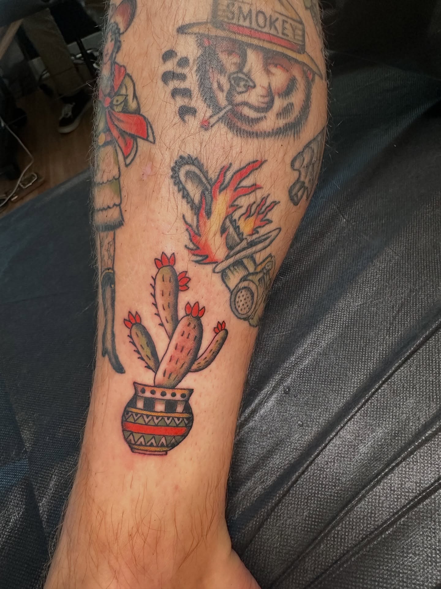 Smokey bear and cactus American traditional tattoo on the forearm by Max Peterson