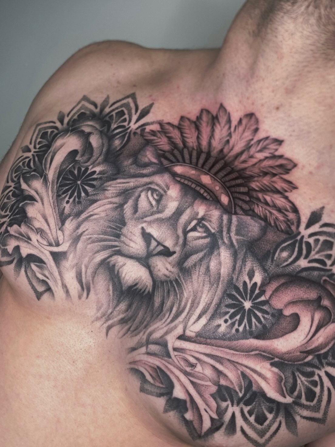 Lion realism tattoo on the chest by Cody Mason