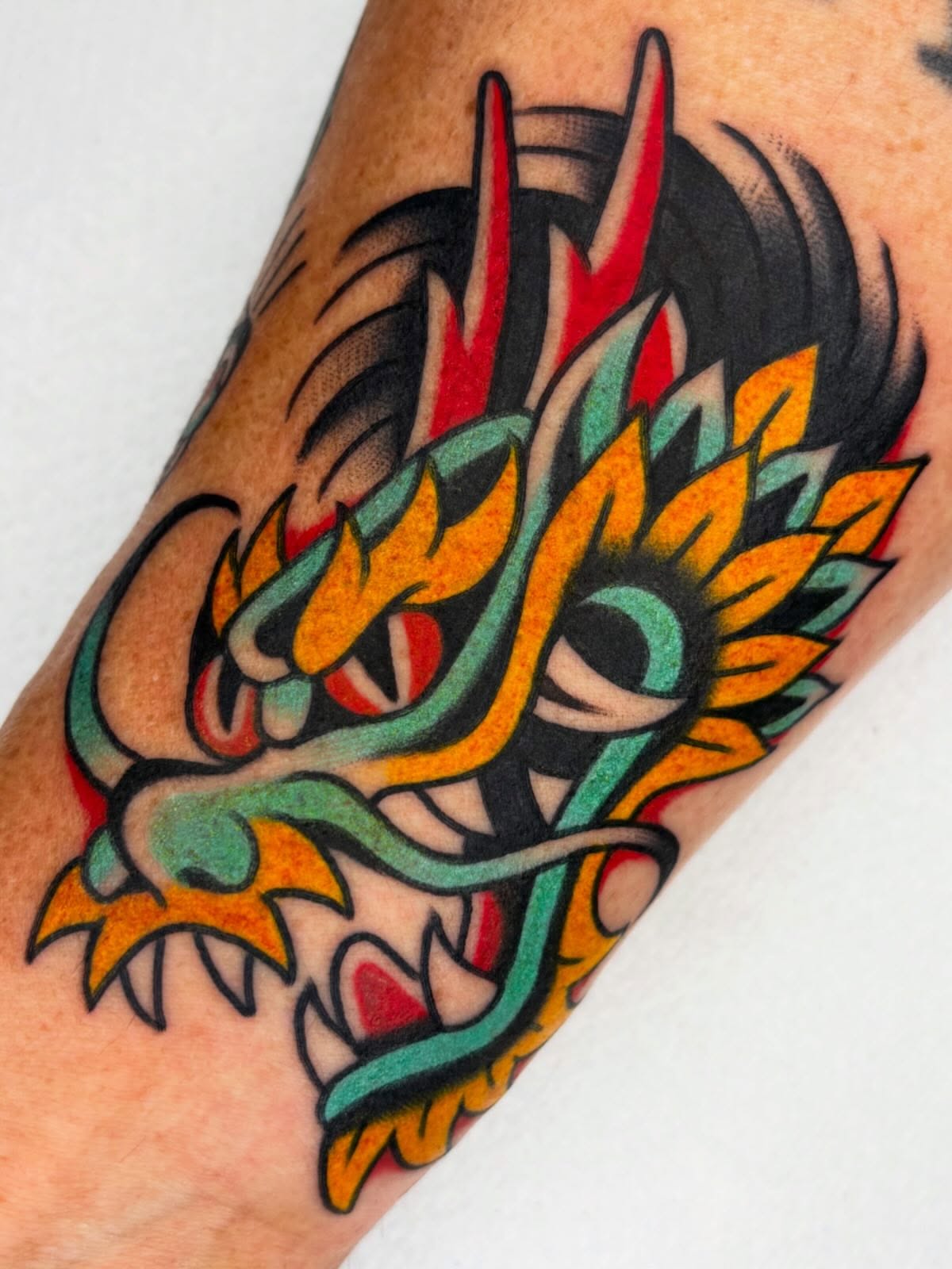 Dragon American traditional tattoo on the forearm by Arturo Ledesma