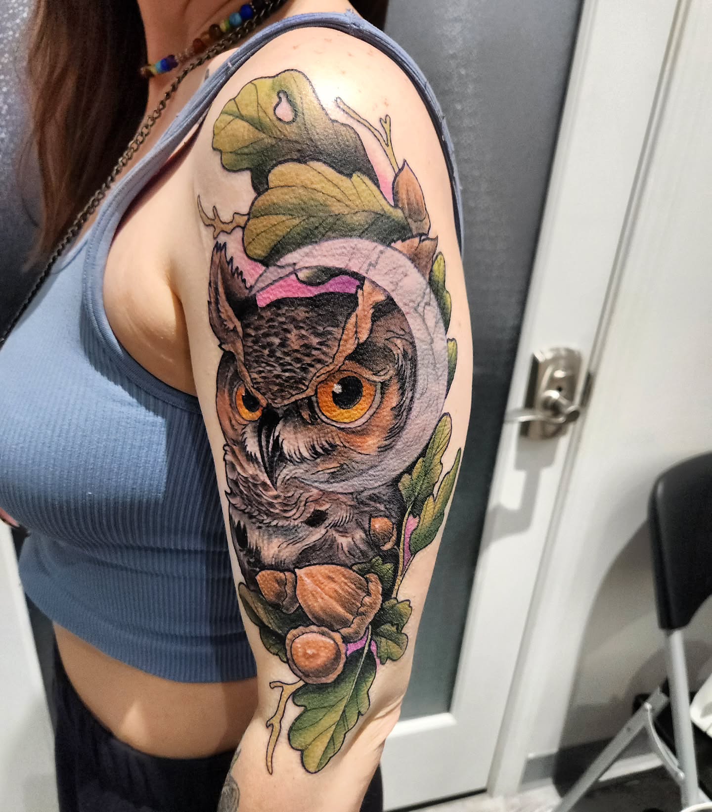 Owl realism tattoo on the upper arm by Chris Bowen