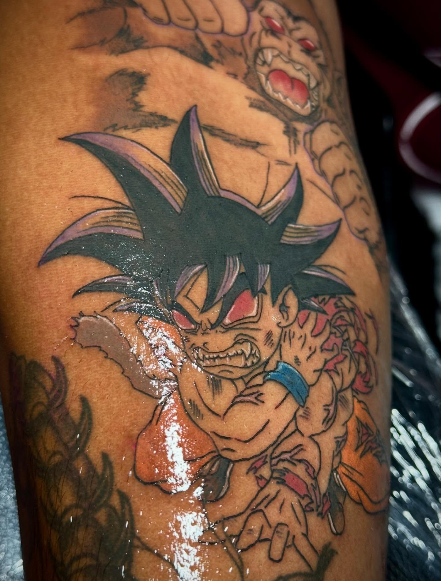 Son goku anime tattoo on the upper arm by abbie michelle