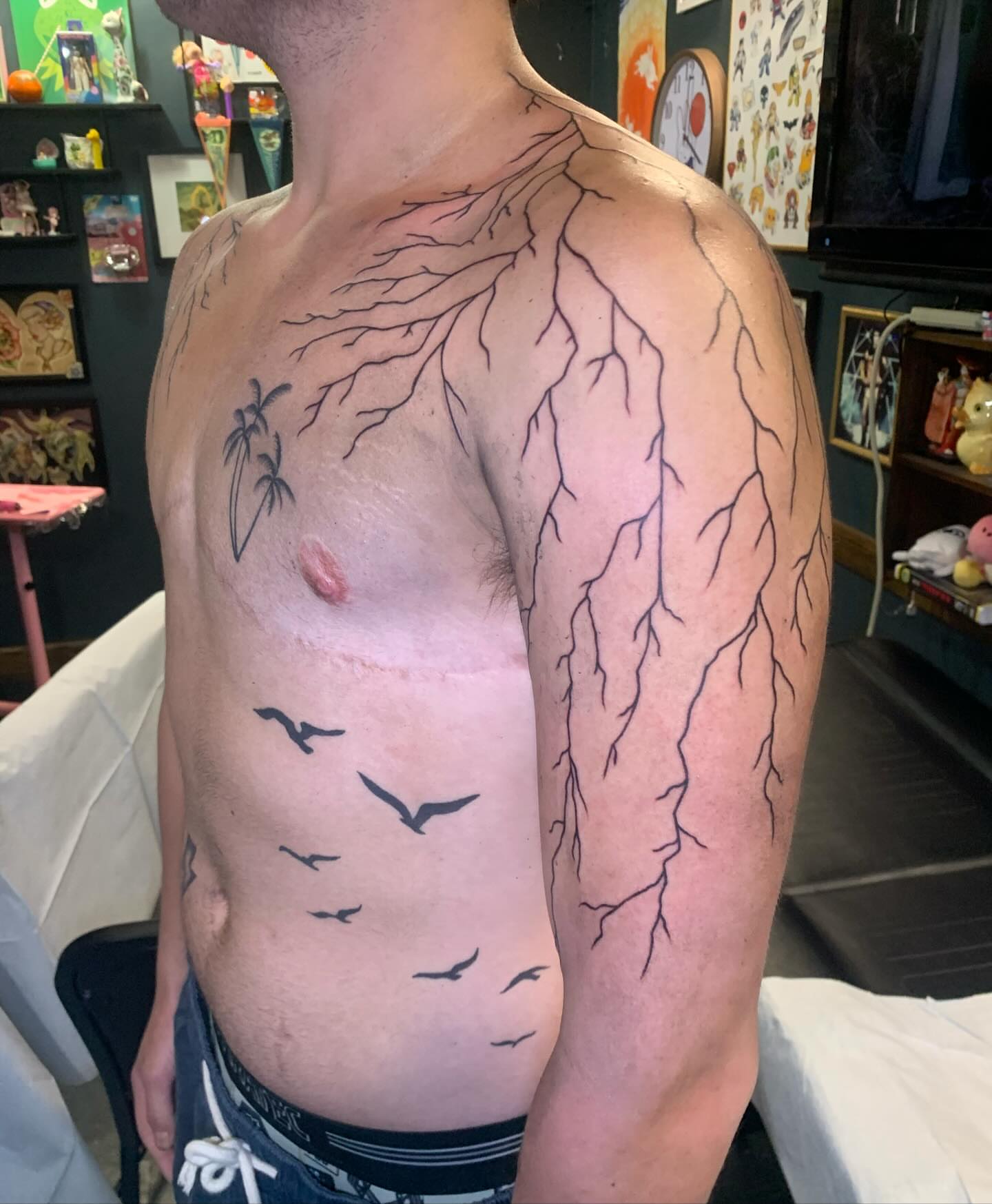 Lightning and birds black and grey tattoo on the chest by Hannah Hahn