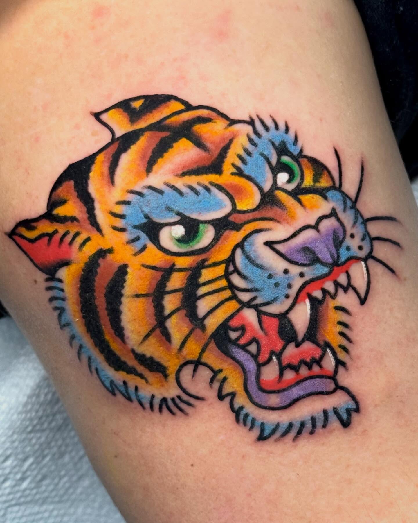 Tiger American traditional tattoo on the thigh by Ty Elias