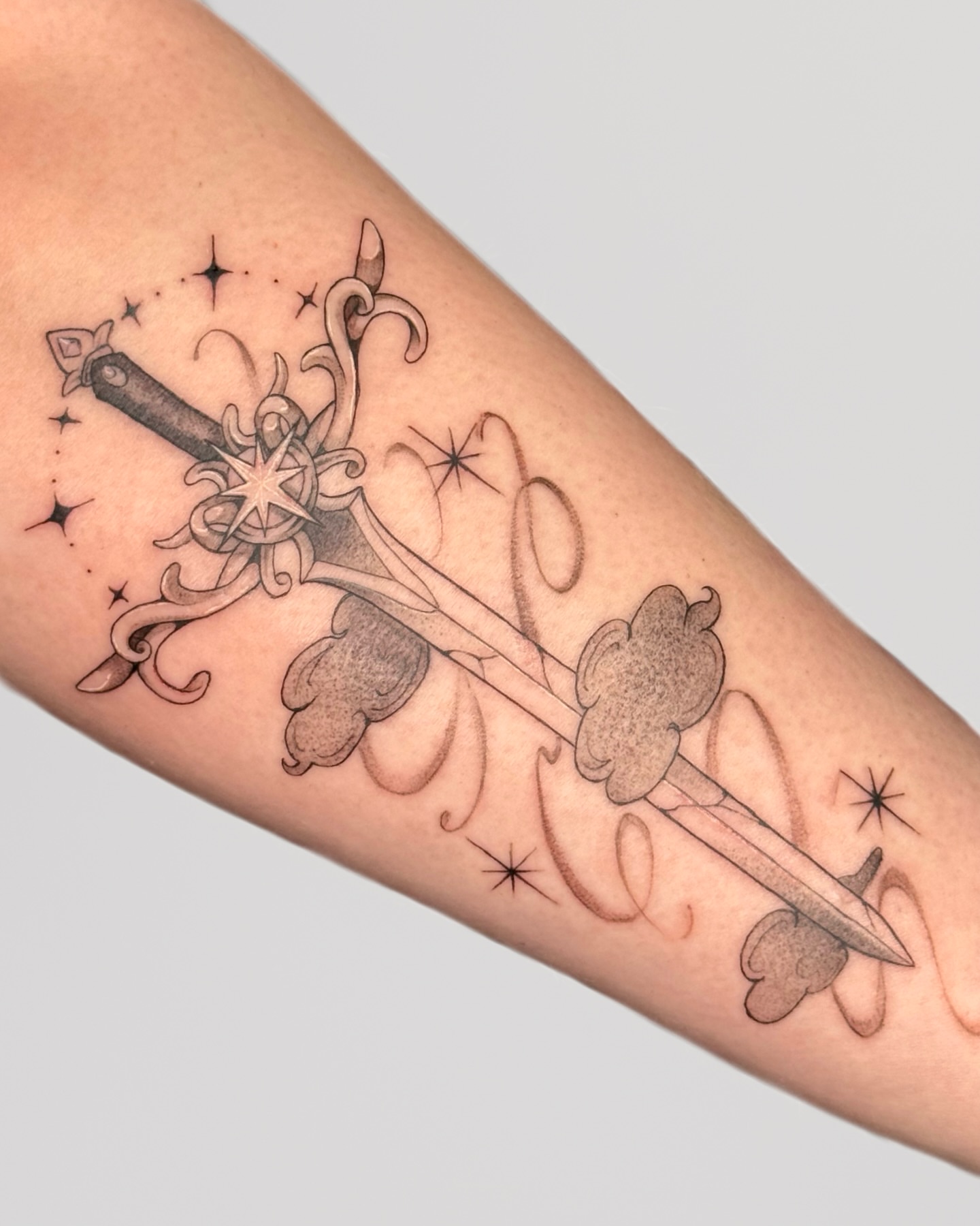Crossed swords black and grey tattoo on the forearm by Suzy