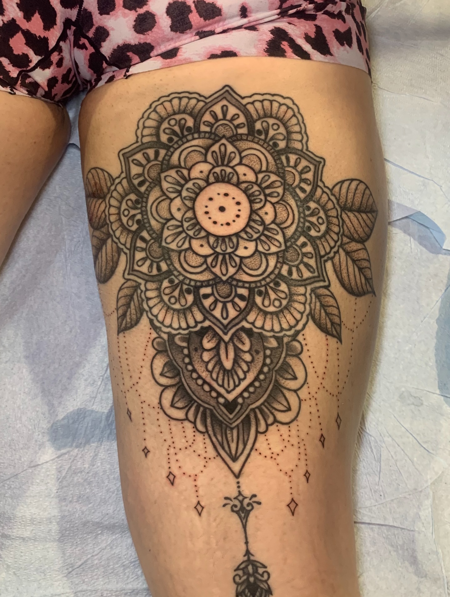 Mandala dotwork tattoo on the thigh by Aubrianna Grisez