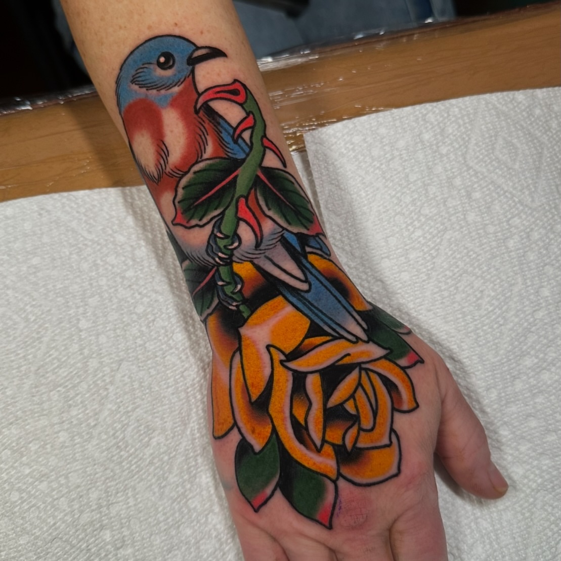 Bird and rose American traditional tattoo on the hand by Schyler Ames, Canal Fulton, Ohio
