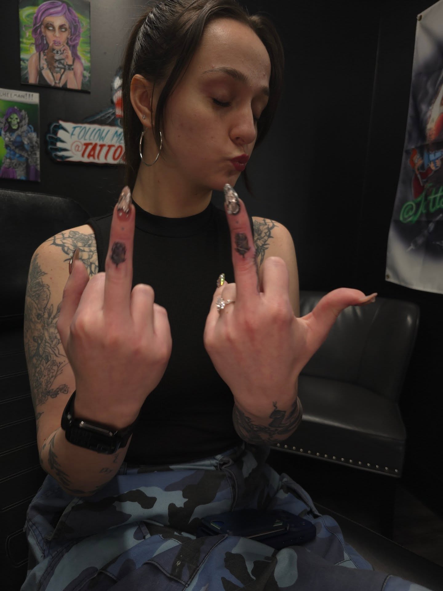 Middle finger black and grey tattoo on the hand by Ian Duncanson