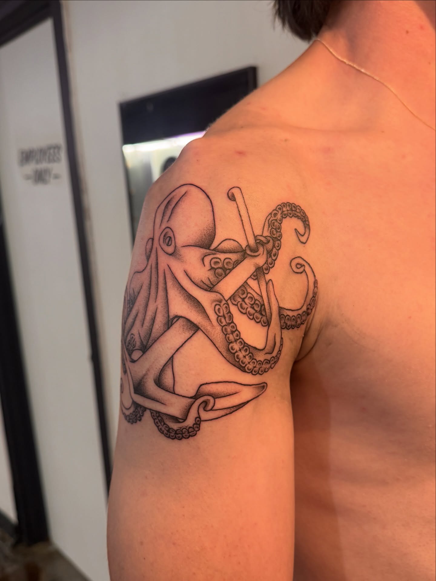 Octopus black and grey tattoo on the shoulder by Sam Padilla