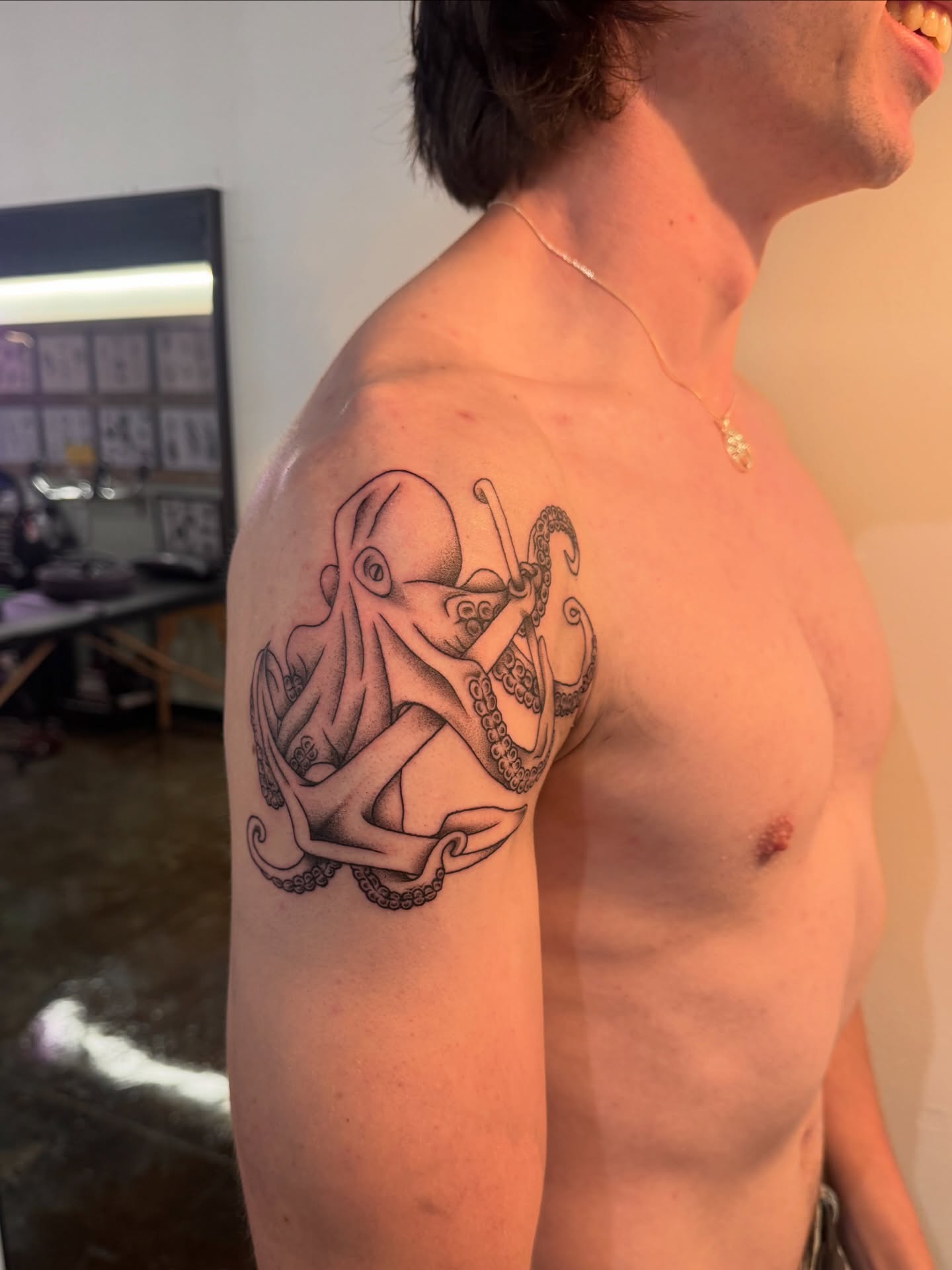 Octopus black and grey tattoo on the shoulder by Sam Padilla