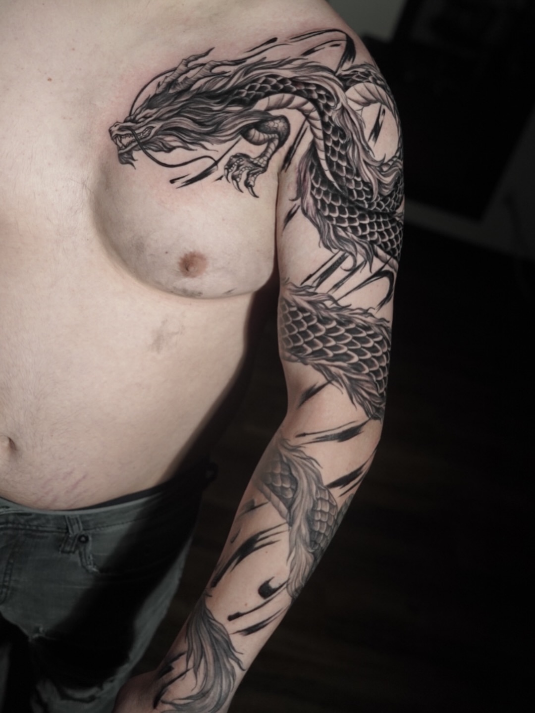Dragon black and grey tattoo on the upper arm by Niko Hosk Cataldo