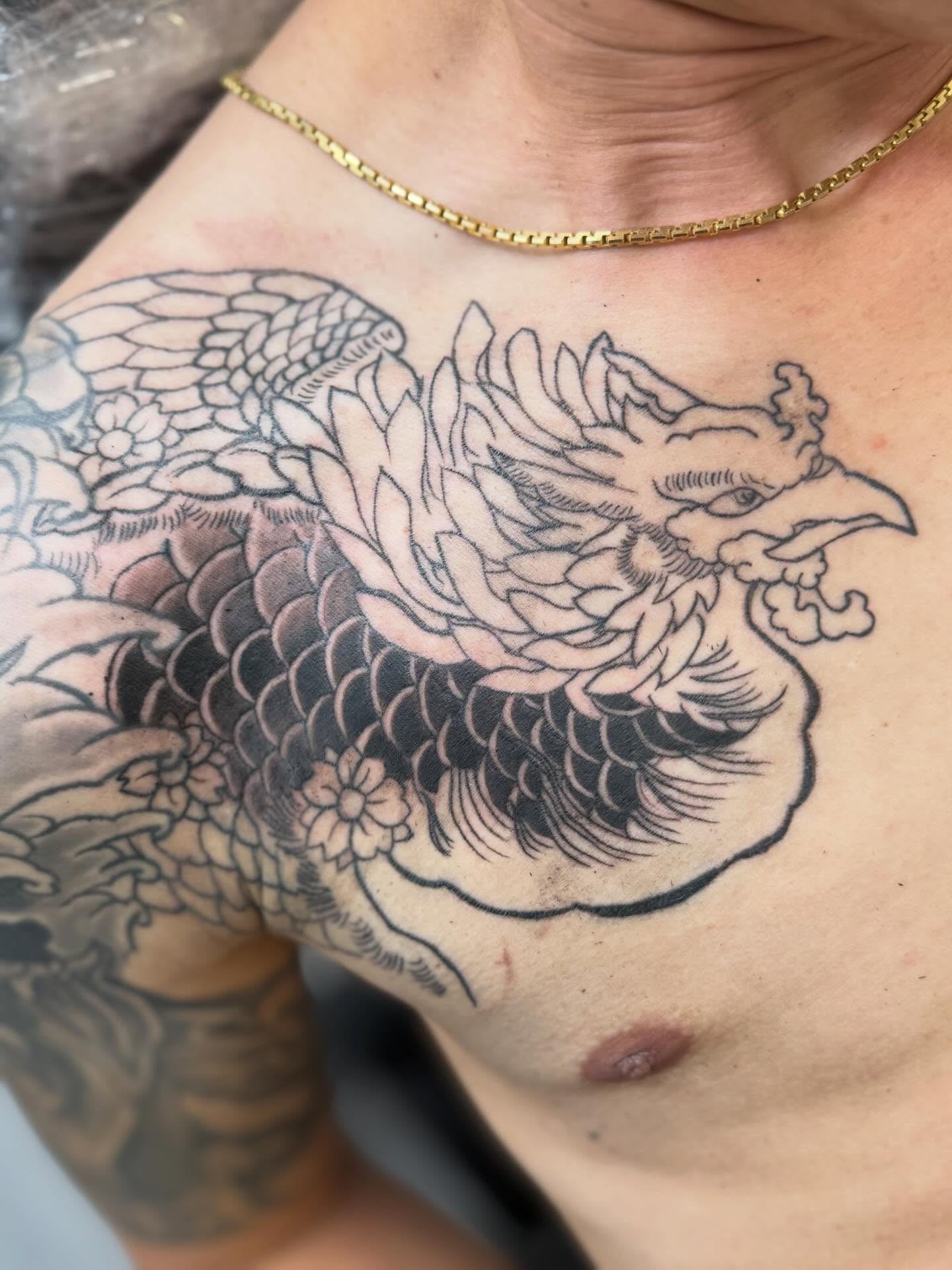 Phoenix black and grey tattoo on the chest by Kai, Charlotte, North Carolina