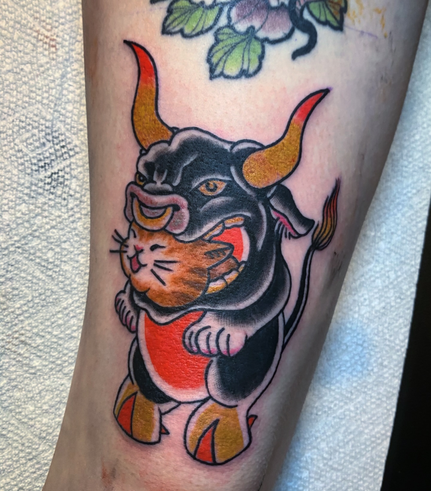 Bull and cat American traditional tattoo on the forearm by Randi Frey