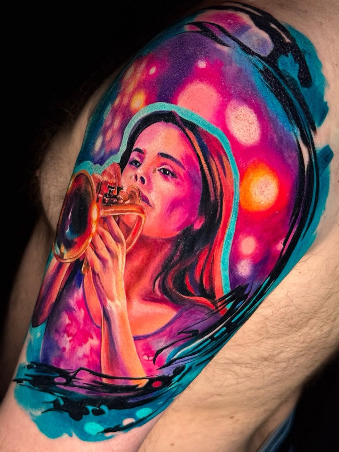 Woman playing trumpet watercolor tattoo on the shoulder by Amy Zager