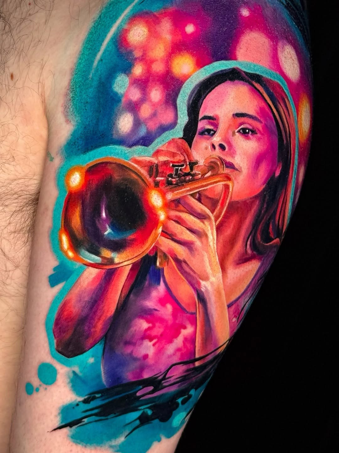 Woman playing trumpet surrealism tattoo on the upper arm by Amy Zager