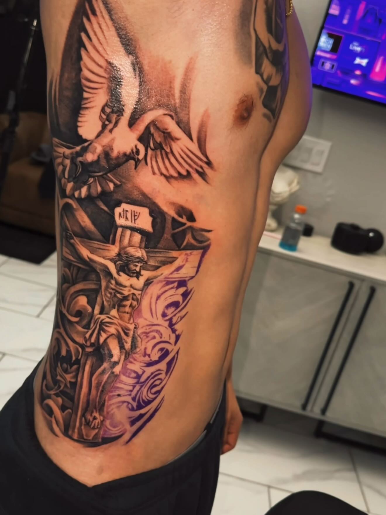 Religious crucifixion scene realism tattoo on the ribs by Adrian gonzalez...