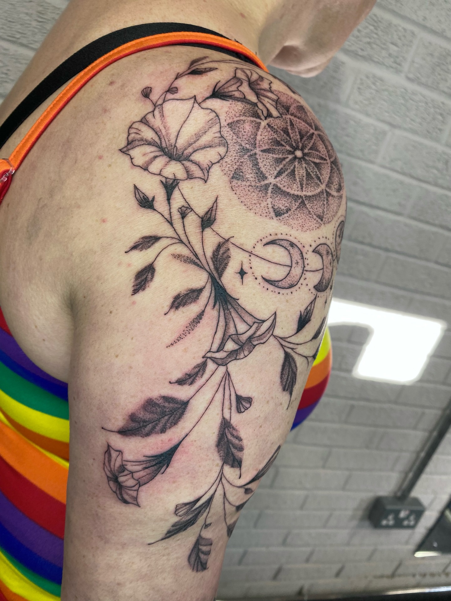 Floral arrangement dotwork tattoo on the shoulder by Ellena Reggiani