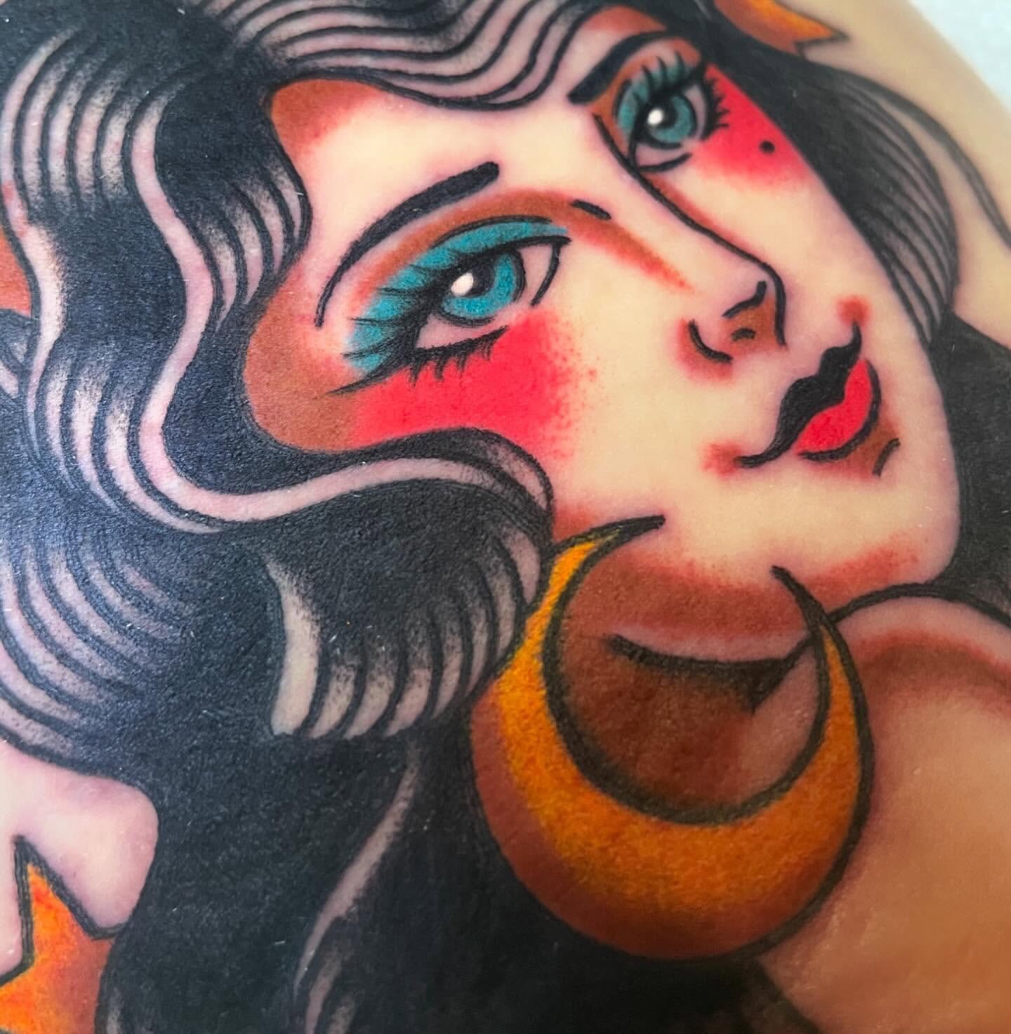 Woman's face American traditional tattoo on the head by Nova Vaughn