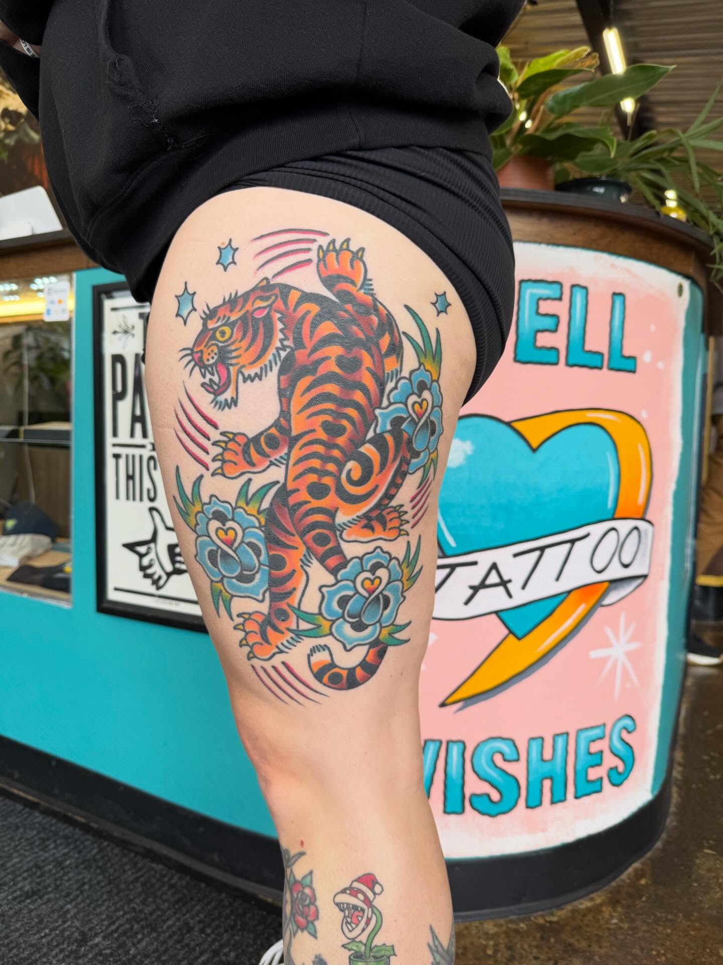 Tiger and floral American traditional tattoo on the thigh by Matt Paw