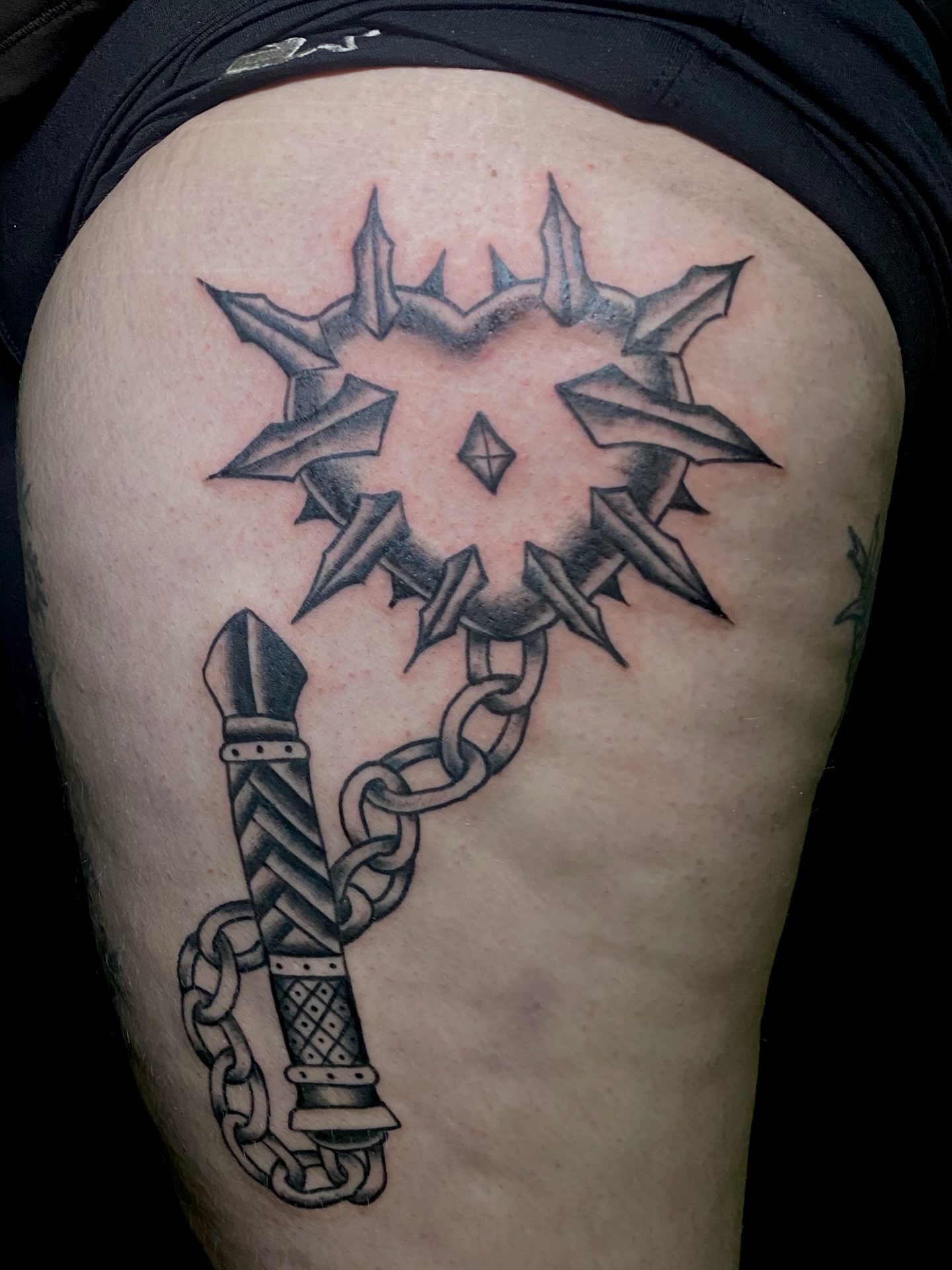 Spiked mace black and grey tattoo on the thigh by Giuseppe T.C.