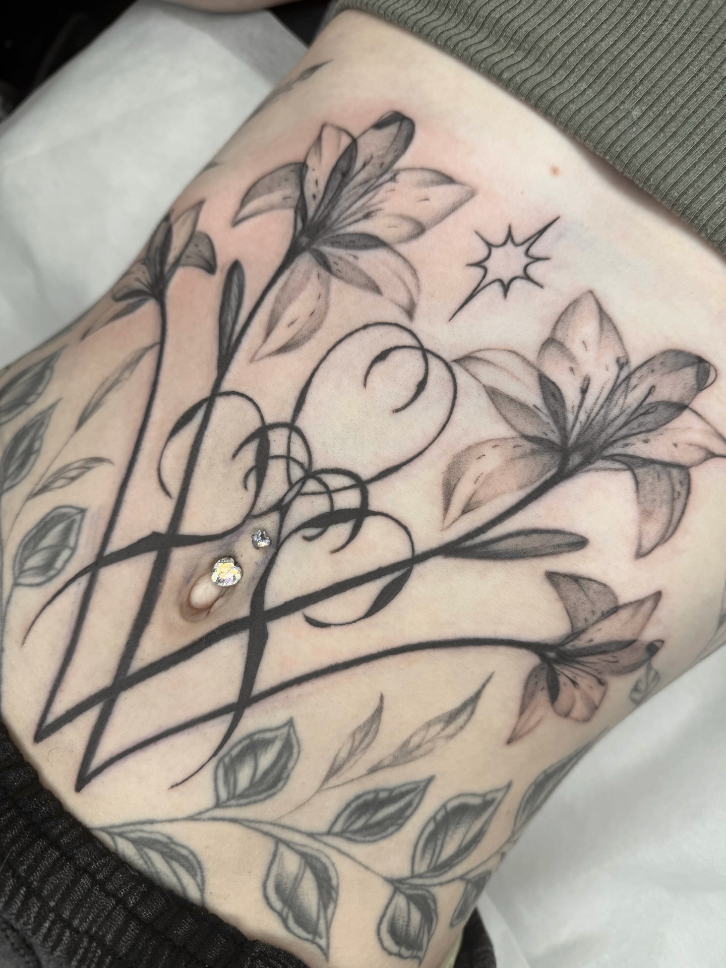 Lily flowers black and grey tattoo on the forearm by Red