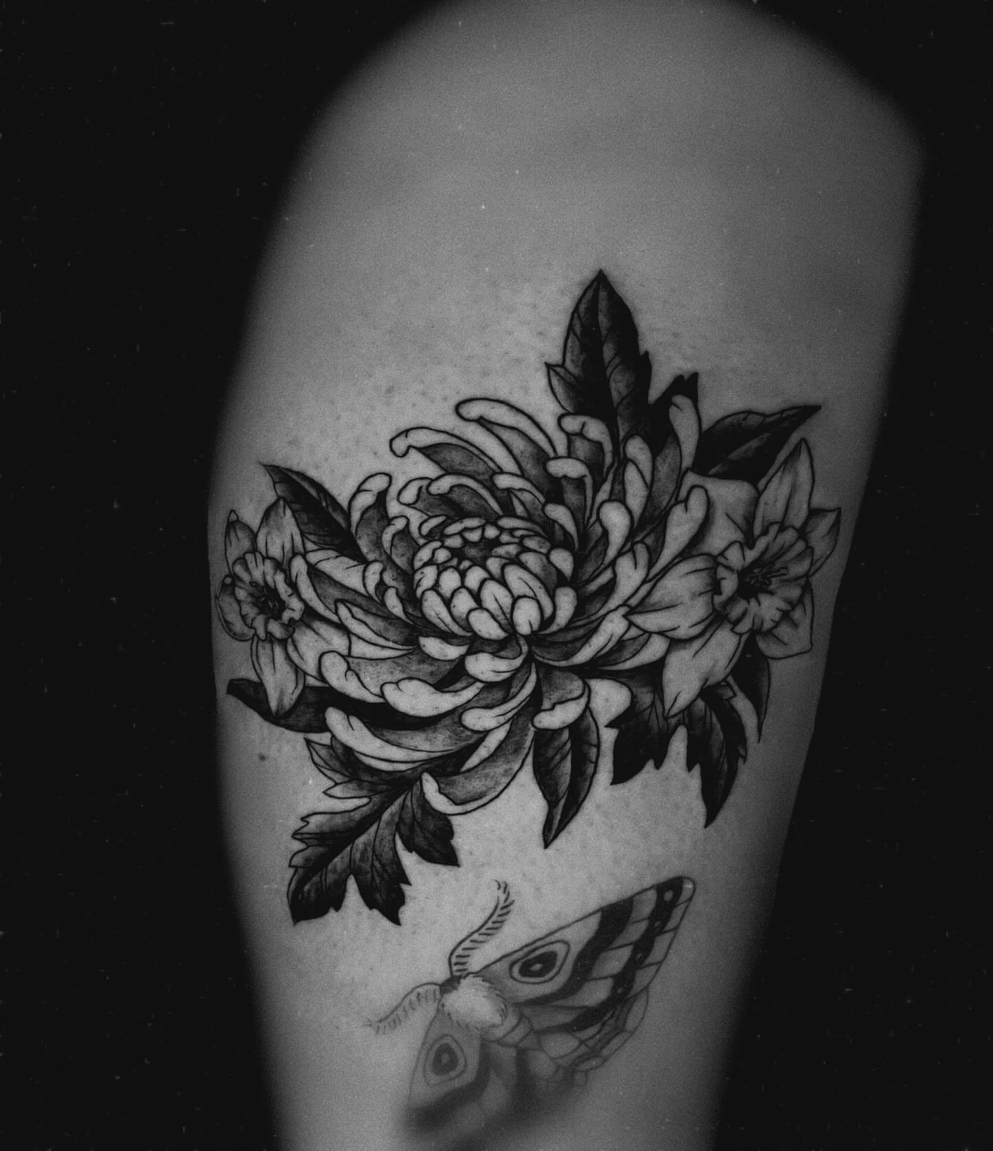 Floral bouquet black and grey tattoo on the forearm by Saint