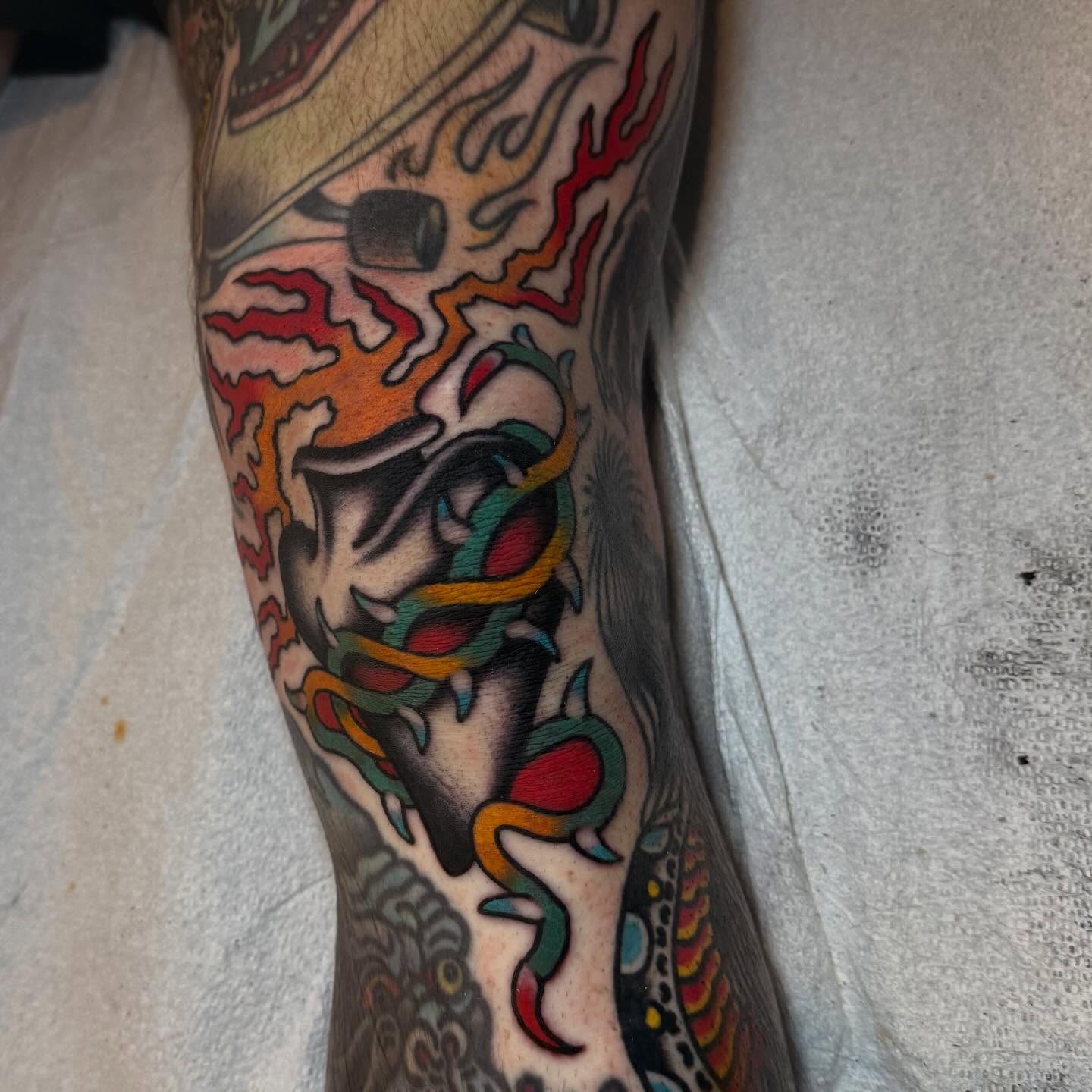 Flame and skull American traditional tattoo on the forearm by Julia Louise