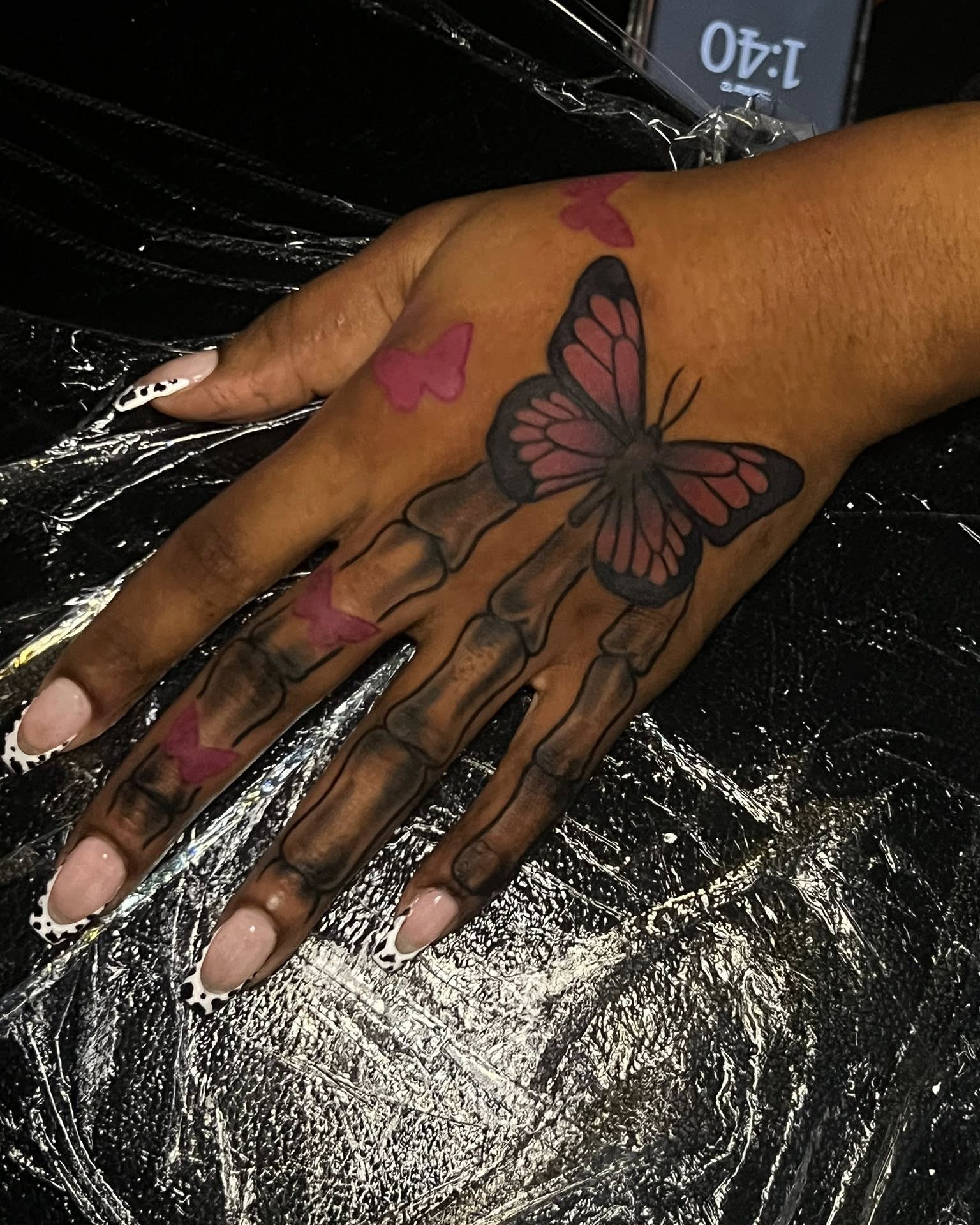 Skeleton hand with butterfly realism tattoo on the hand by Ferlandis Fitch, Long Beach, California