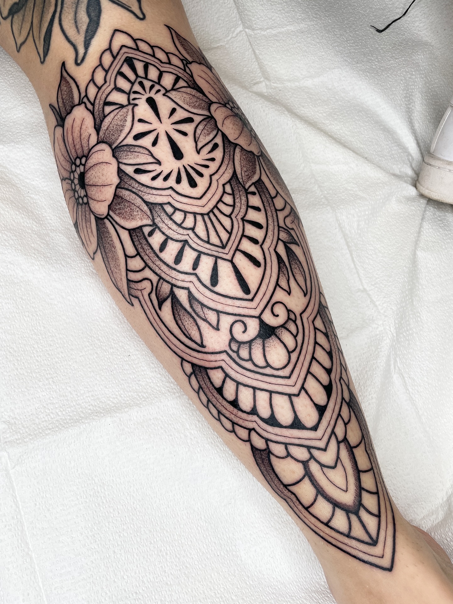 Mandala geometric tattoo on the forearm by Emily Lux