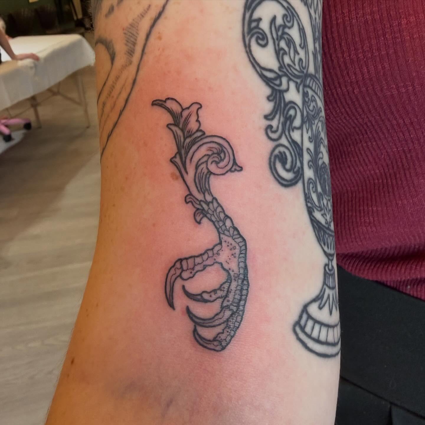 Serpent and flower black and grey tattoo on the forearm by Patrick Carroll