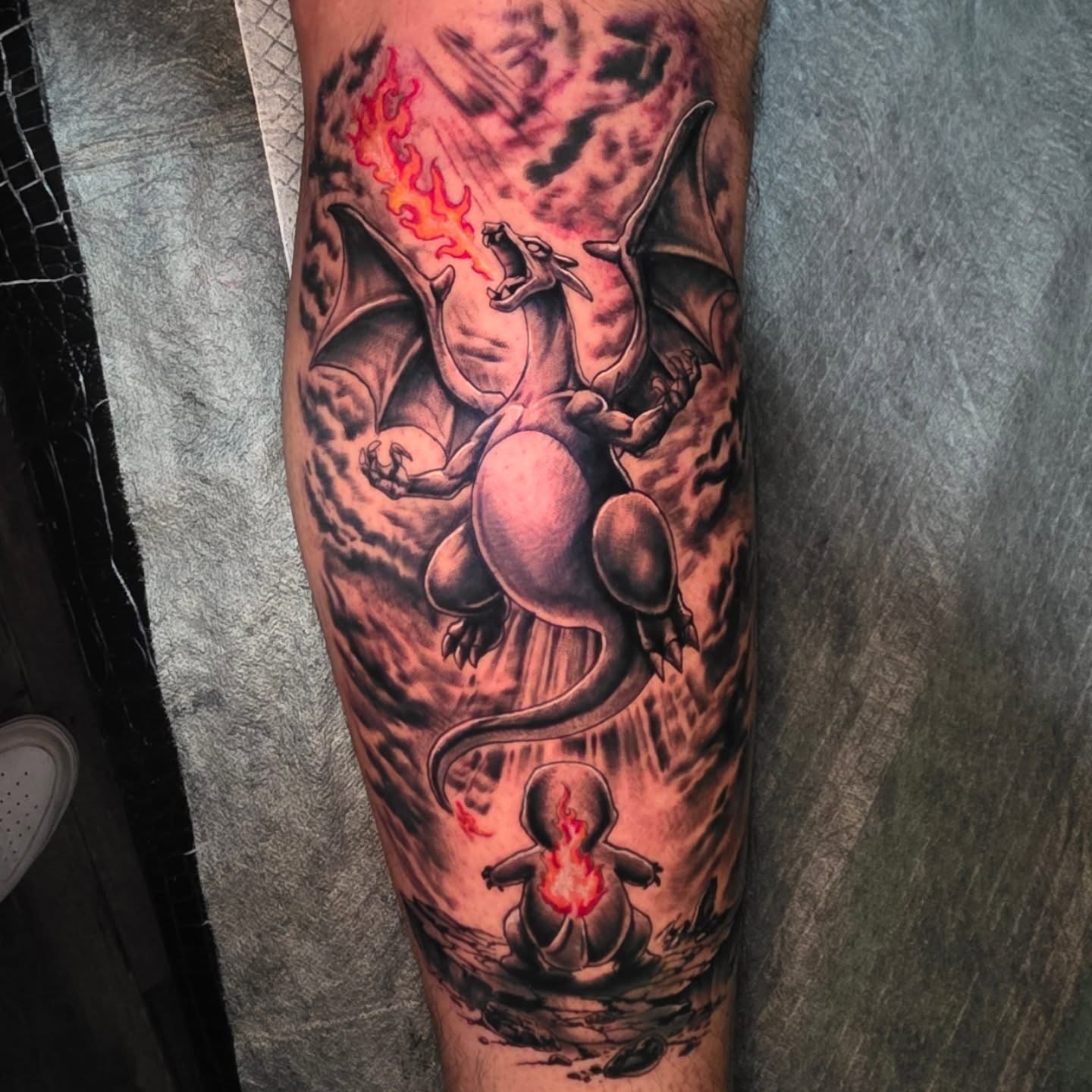 Dragon and baby dragon realism tattoo on the calf by komik tattoos