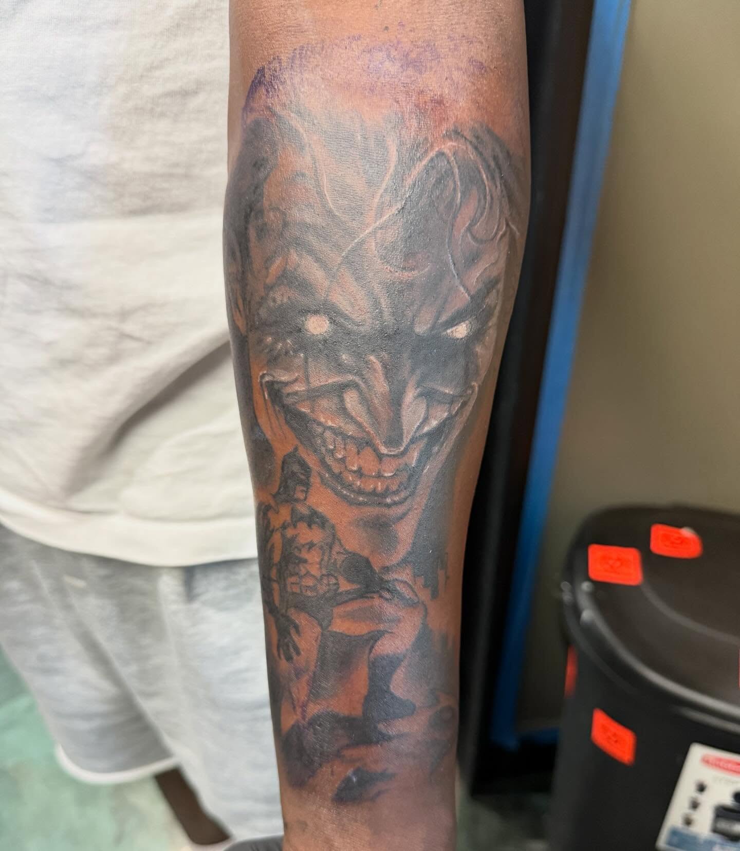 Joker dark realism tattoo on the forearm by Devon Beyer, Mission, Kansas