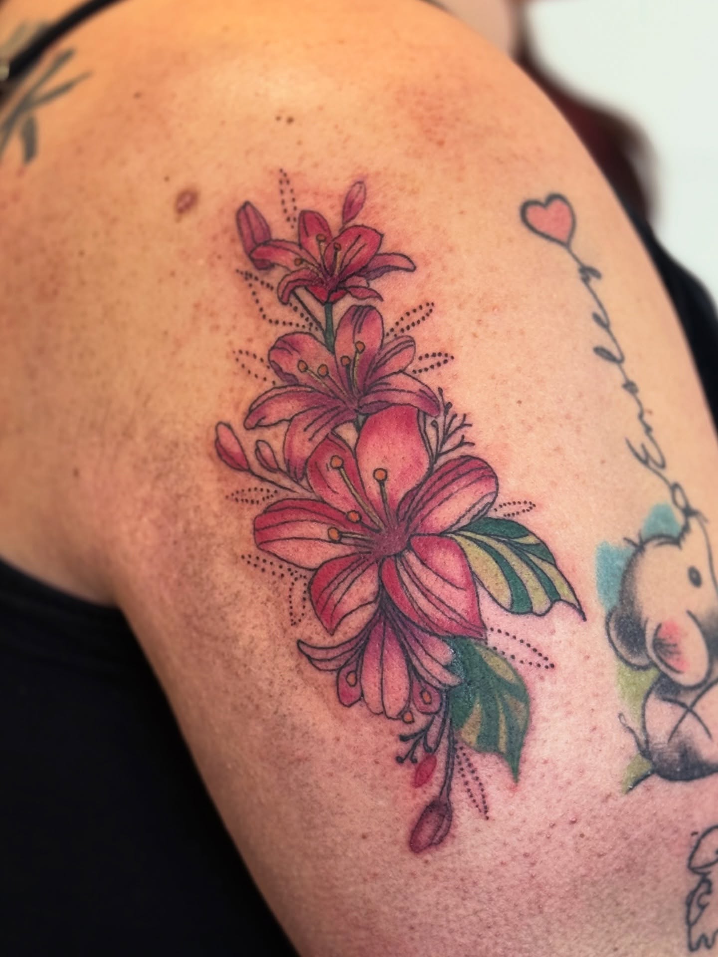 Lilies American traditional tattoo on the shoulder by Whimsy Ink