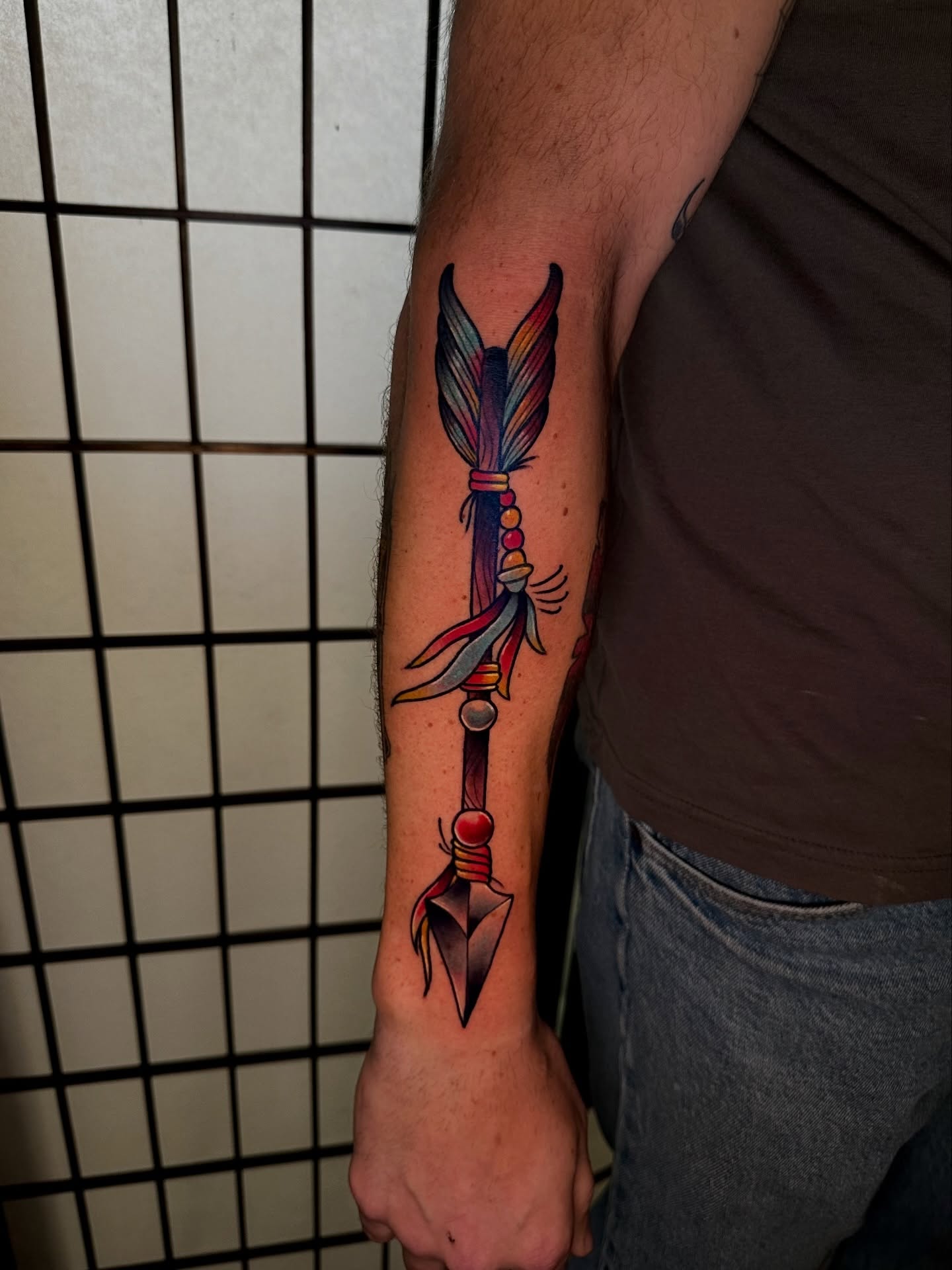 Arrow with feathers neo-traditional tattoo on the forearm by Robert Douglas